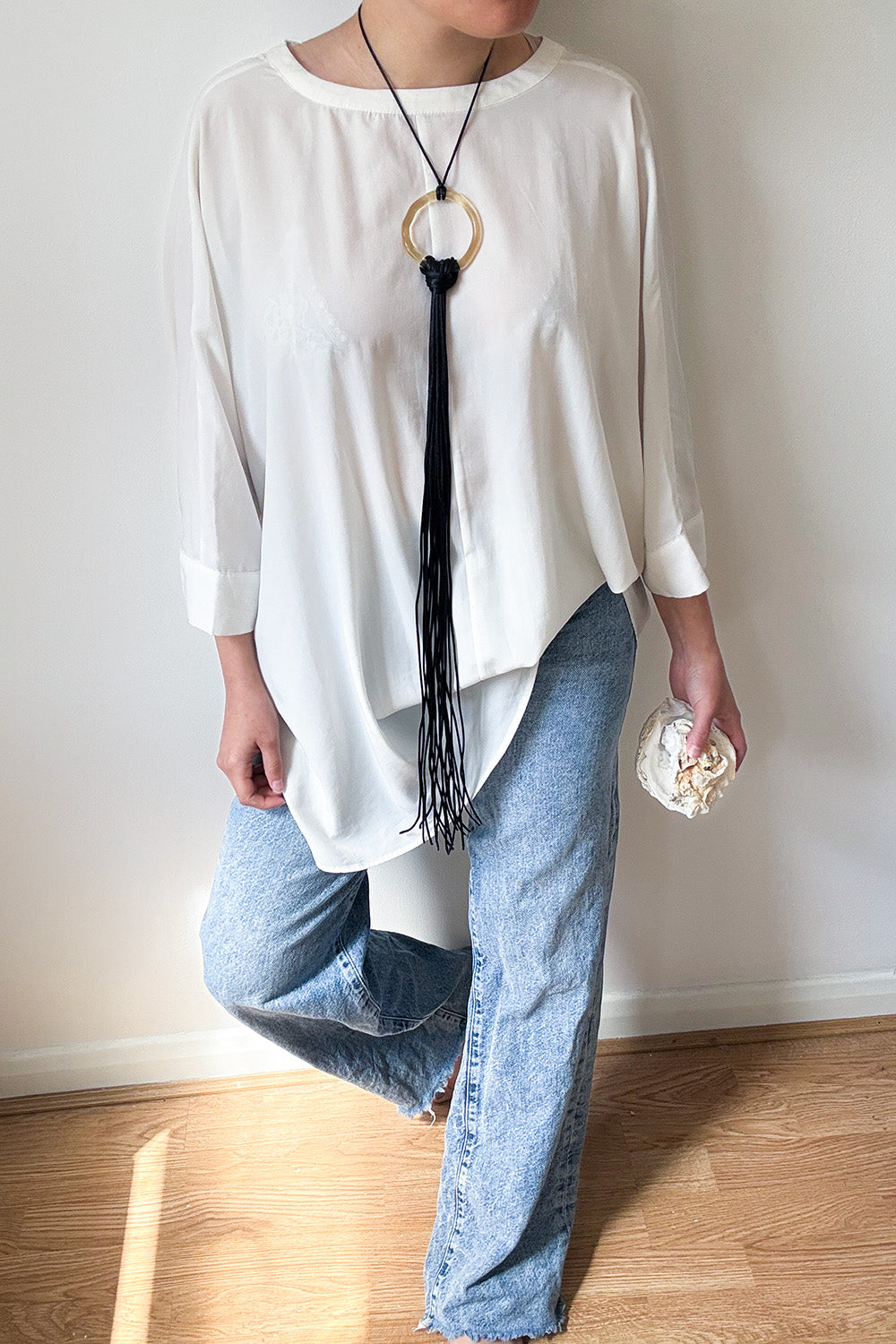 El Jaleo glass necklace worn as necklace on model, ring in champagne and fringe in black, handcrafted in London by Beryeni