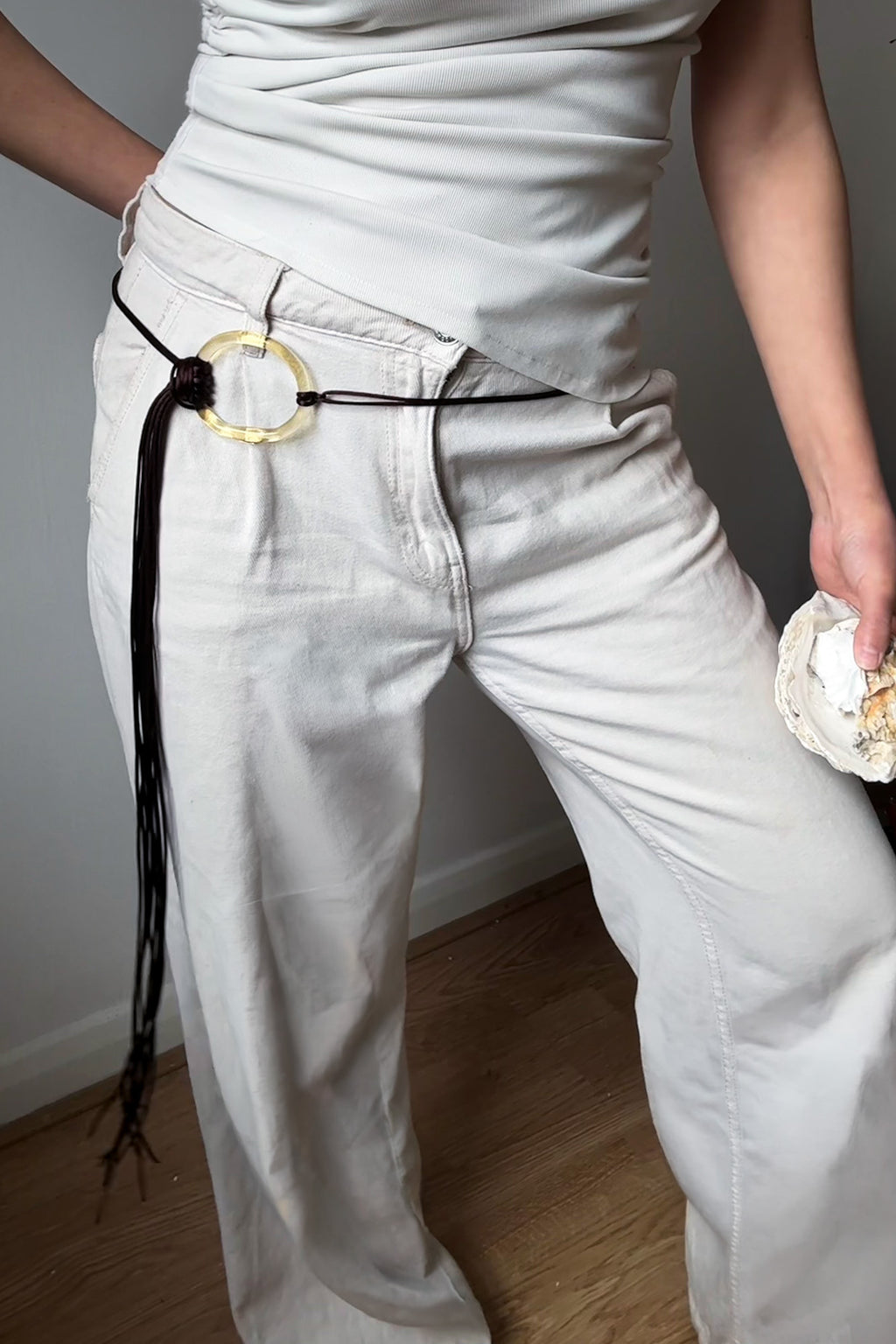 El Jaleo glass necklace worn as belt on model, ring in champagne and fringe in brown, handcrafted in London by Beryeni